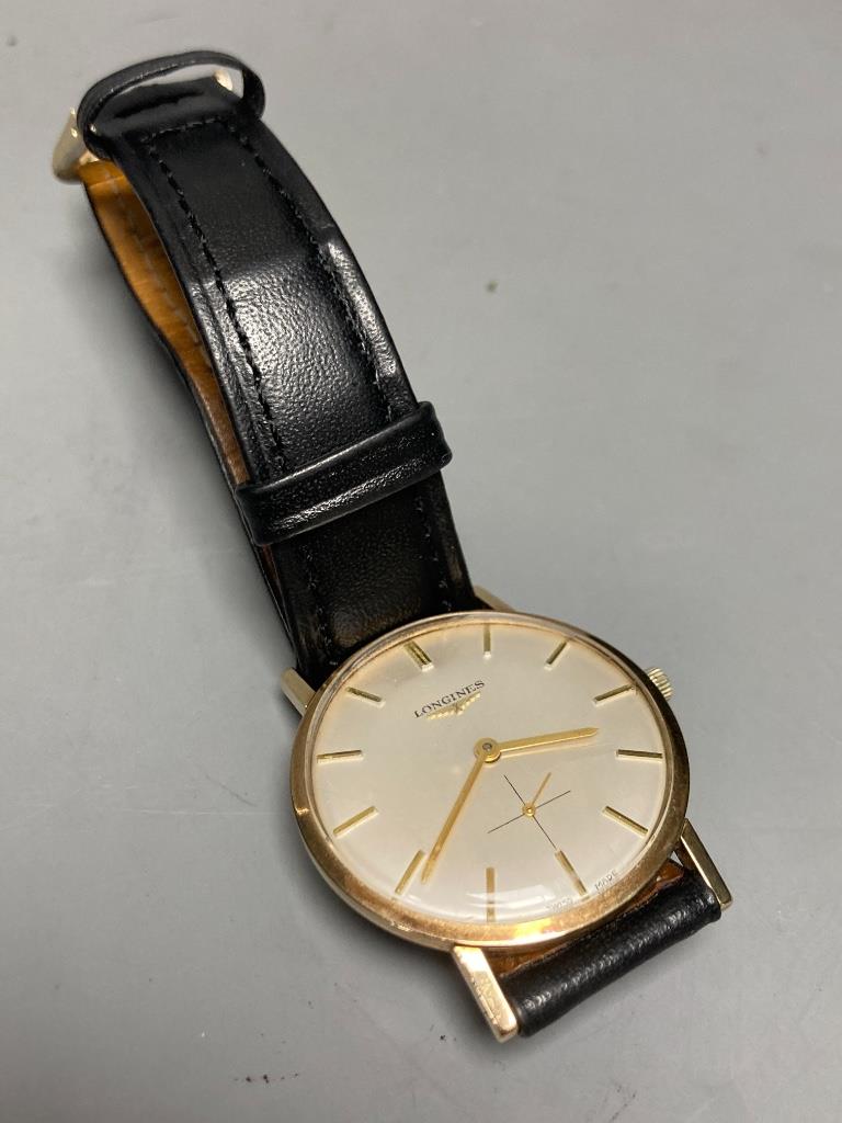 A gentleman's 1960's 9ct gold Longines manual wind wrist watch, on associated leather strap, case diameter ex. crown, 33mm, gross weight 24,4 grams.